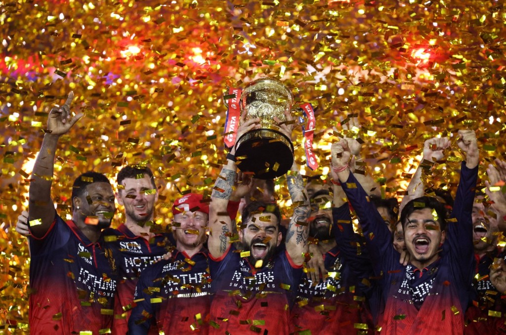 Virat Kohli lifts the trophy as he celebrates with teammates after winning the Indian Premier League. REUTERS 