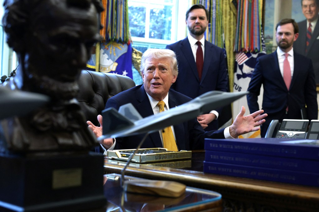 U.S. President Donald Trump speaks to the media as Vice President JD Vance (C) and Federal Trade Commission Chairman Andrew Ferguson (R) look on during a ceremony in the Oval Office of the White House on March 16, 2026 in Washington, DC. Trump signed an executive order that creates a task force on fraud to be headed by Vice President J.D. Vance. Alex Wong/Getty Images/AFP