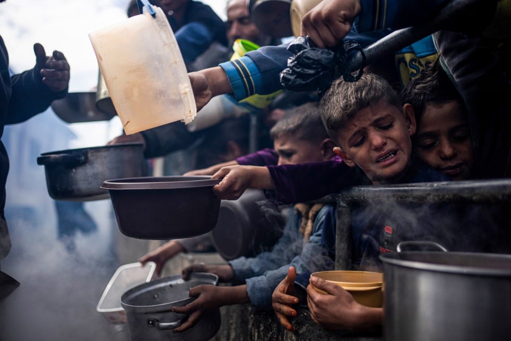 Palestinians line up for a free meal in Rafah, Gaza Strip, on 16 February. Photograph: Fatima Shbair/AP