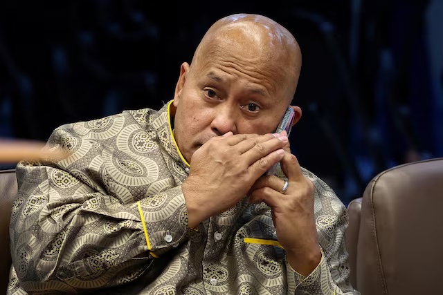 Philippine Senator Ronald "Bato" dela Rosa, the chief enforcer of former president Rodrigo Duterte's drug war, takes a phone call during a session at the Senate, which holds him under protective custody amid an International Criminal Court warrant, in Pasay City, Metro Manila, Philippines, May 13, 2026. REUTERS/Eloisa Lopez/File Photo