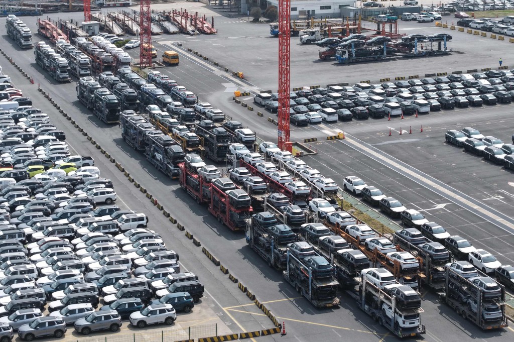 Chinese-made EV cars awaiting export are seen parked at Shanghai port on June 9, 2026. (Photo by CN-STR / AFP)