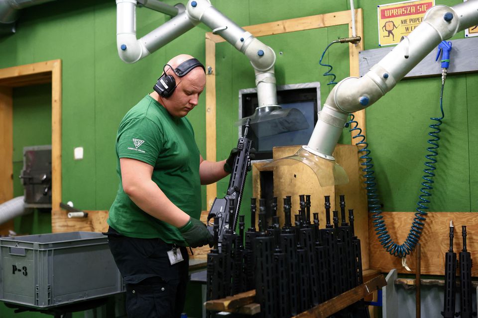 A worker checks the quality of firing of GROT C16 FB-M1, modular assault rifle system at PGZ (Polska Grupa Zbrojna) arms factory Fabryka Broni Lucznik in Radom Poland. (Reuters) 