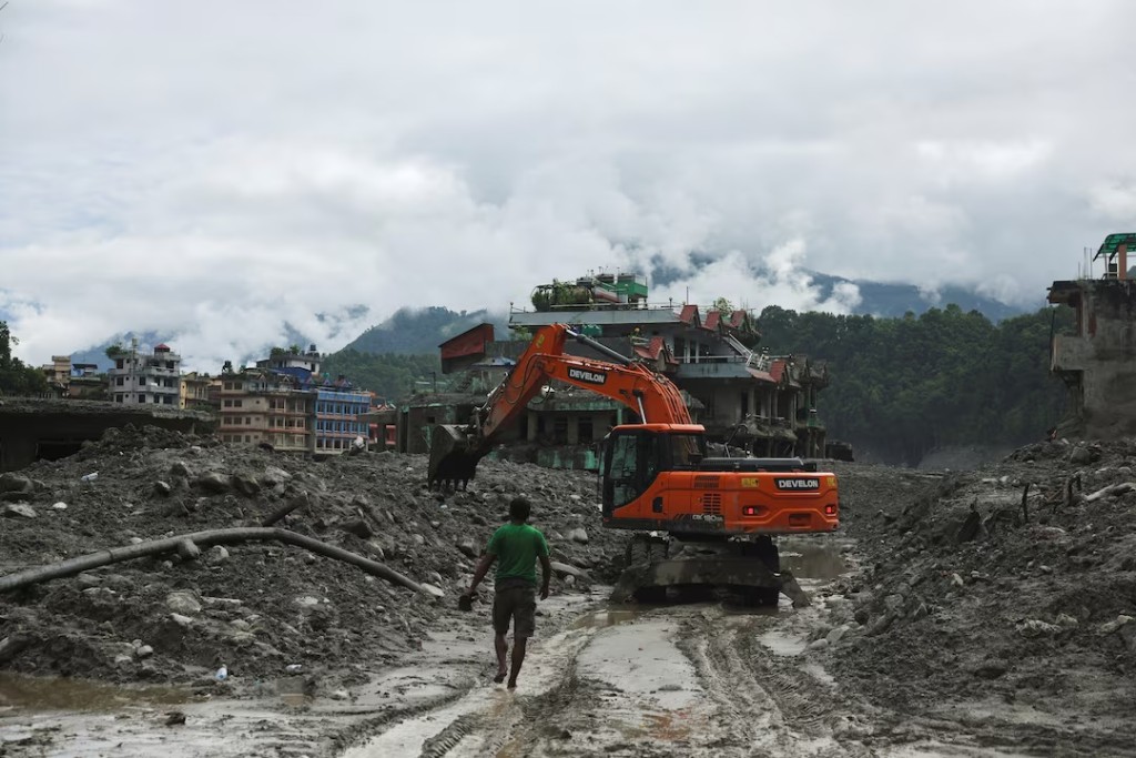 An excavator clears a muddy path after flash floods and a mudslide in Trishuli, Nuwakot district, Nepal, September 1, 2026. REUTERS/Francis Mascarenhas