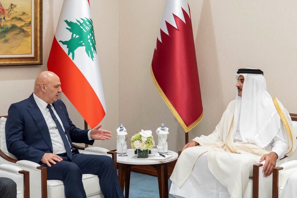 This handout picture released by the he Qatar News Agency (QNA) shows Qatar's Emir Sheikh Tamim bin Hamad Al-Thani (Right) meeting with Lebanon's President Joseph Aoun on the sidelines of the 2025 Arab-Islamic emergency summit in Doha on September 15, 2025. (Photo by Qatar News Agency / AFP)