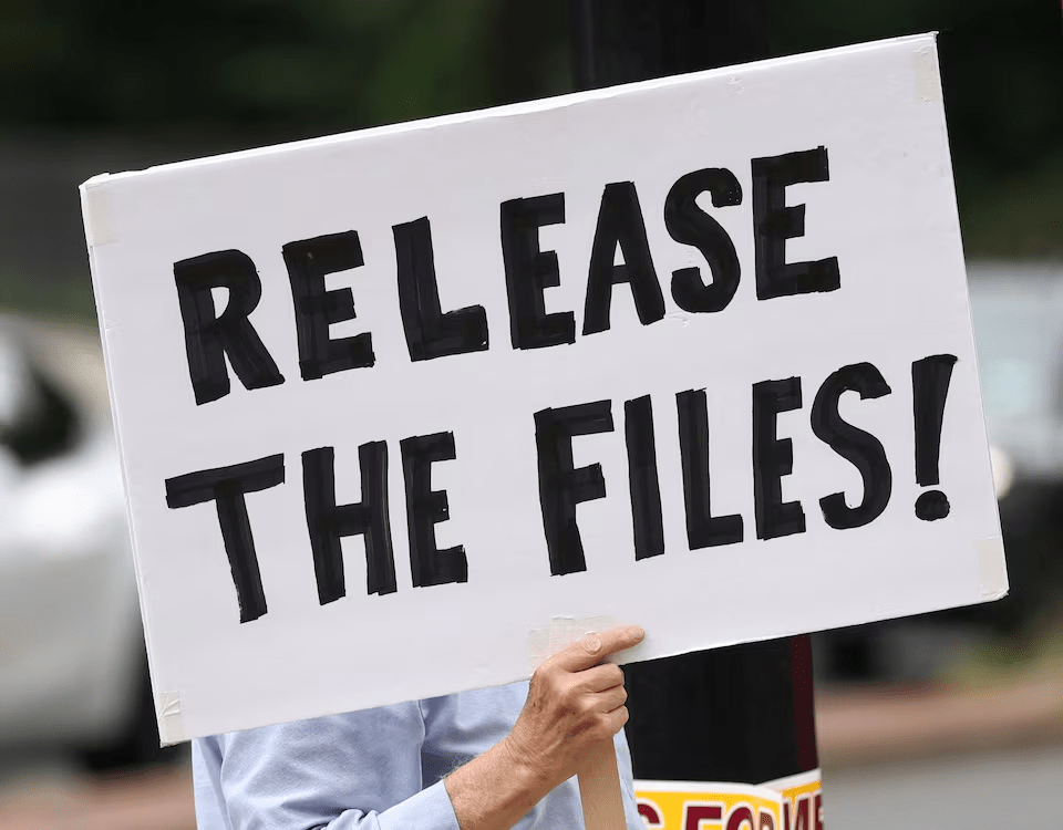 A protester calling for a release of the Epstein files holds a sign in Washington, D.C., U.S., August 6, 2025. REUTERS/Kevin Lamarque/File Photo