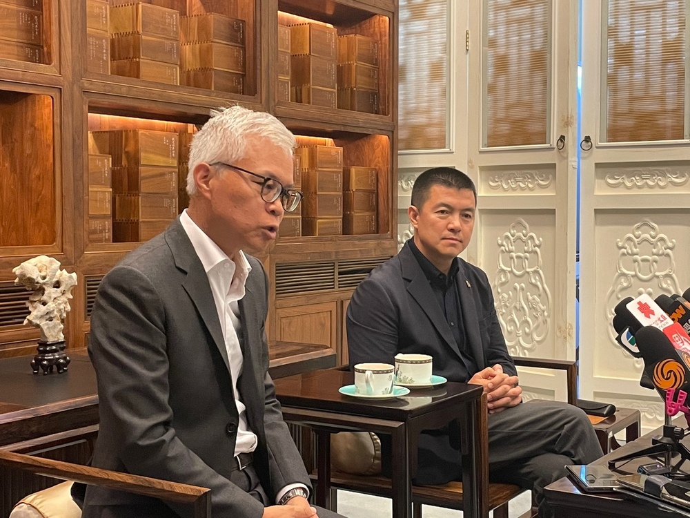 Louis Ng speaks as Lou Wei looks on. Louis Ng speaks as Lou Wei looks on.