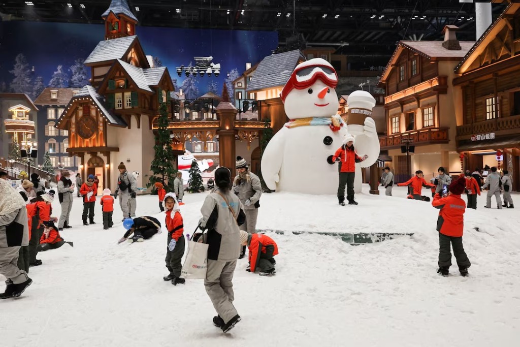 People enjoy the snow at Shanghai L+SNOW Indoor Skiing Theme Resort amid an orange alert for heat in Shanghai, China August 28, 2025. REUTERS/Go Nakamura 