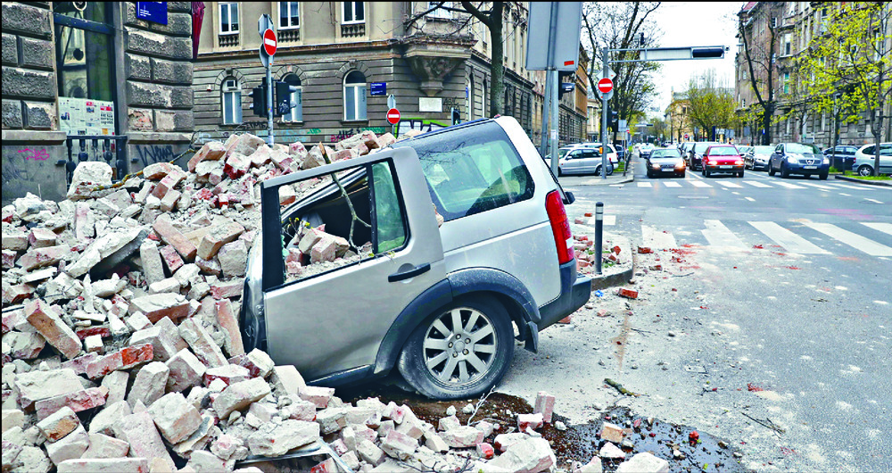 A car is crushed by falling debris during the quake, which also damaged one of the spires of Zagreb's iconic cathedral. REUTERS, AP A car is crushed by falling debris during the quake, which also damaged one of the spires of Zagreb's iconic cathedral. REUTERS, AP