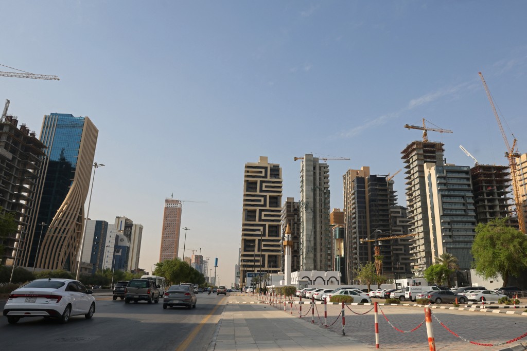 Cars drive past city skyscrapers in Riyadh on October 11, 2026. (AFP)