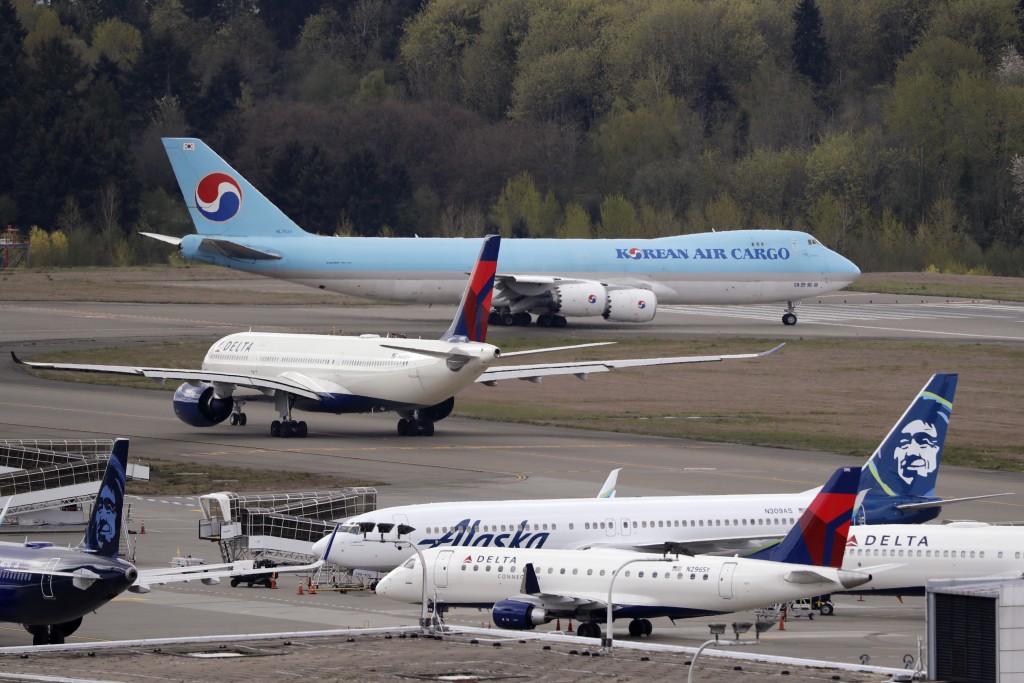 Korean Air Cargo jet taxis past other waiting aircraft to take-off at Seattle-Tacoma International Airport, 2020. AP Photo