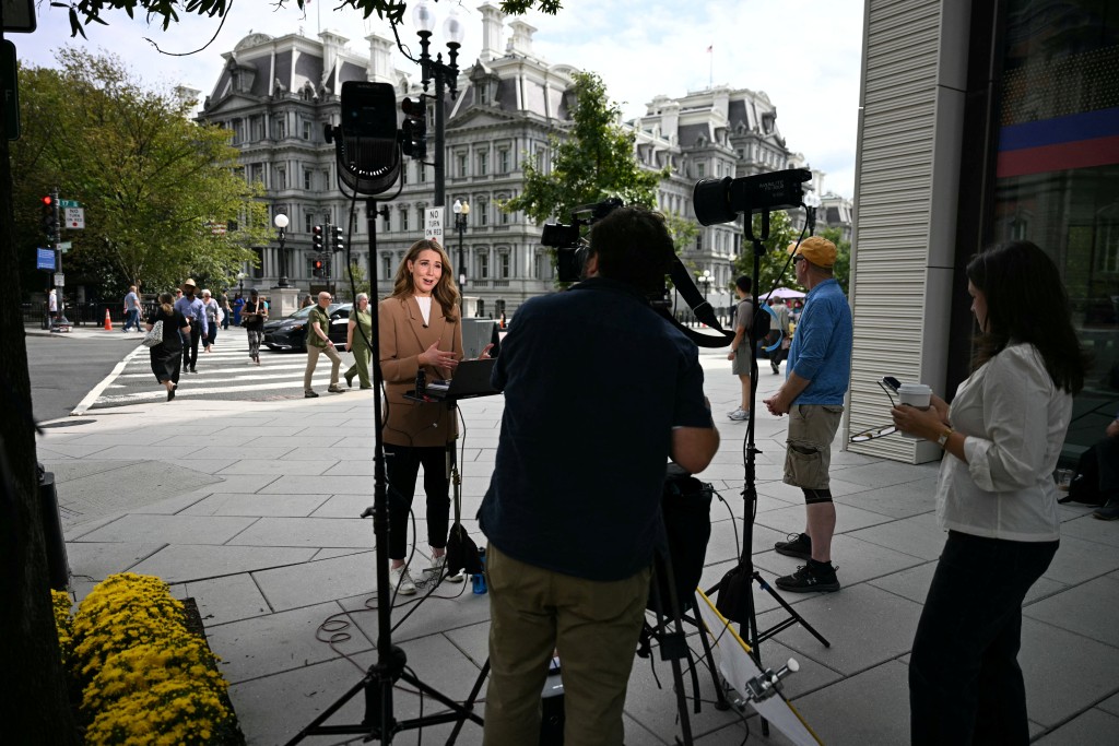 CNN reporter Julia Benbrook gives a live report near the White House in Washington, DC, on September 19, 2026. (AFP)
