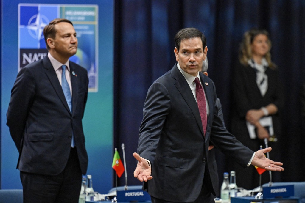 Photo by JONATHAN NACKSTRAND / AFP  US Secretary of State Marco Rubio (R) gestures in front of Poland's Foreign Minister Radosław Sikorski at the NATO Foreign Ministers' meeting in Helsingborg, Sweden, on May 22, 2026.