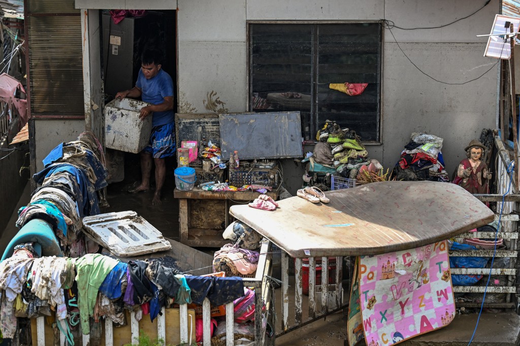 Residents clean up their damaged houses in the aftermath of Typhoon Kalmaegi in Talisay, in the province of Cebu on November 5, 2025. (Photo by Jam STA ROSA / AFP)