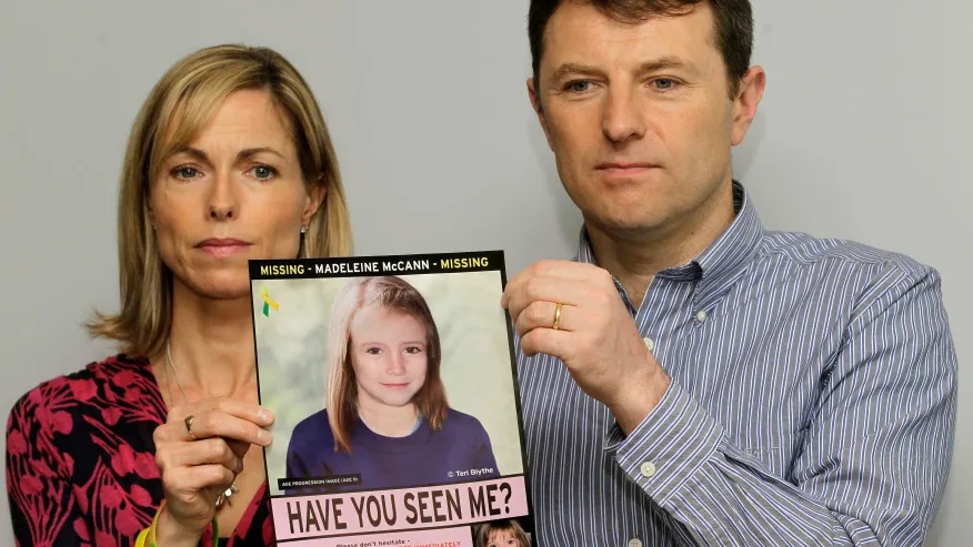 Kate and Gerry McCann pose for the media with a missing poster depicting an age progression computer generated image of their still missing daughter Madeleine during a news conference in London, May 2, 2012.   (AP Photo/Sang Tan, File)