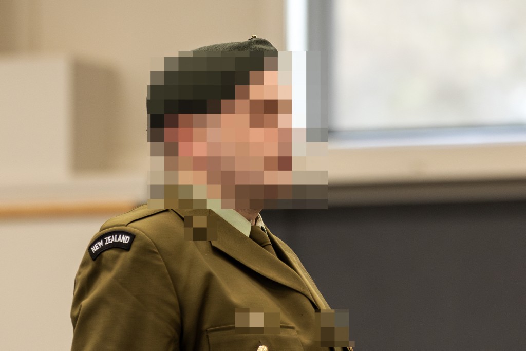 A New Zealand soldier stands at a makeshift courtroom at the Linton Military Camp located near the city of Palmerston North in New Zealand on August 18, 2025. (Photo by Adele Rycroft / POOL / AFP)