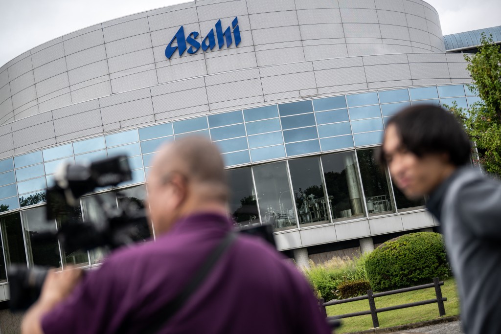 Photo by PHILIP FONG / AFP  Members of the media record footage outside the Asahi Group Holdings' Ibaraki Brewery, which produces around 5.9 million cans of beer daily, during a media tour of the facility in Moriya city, Ibaraki Prefecture on September 7, 2026.