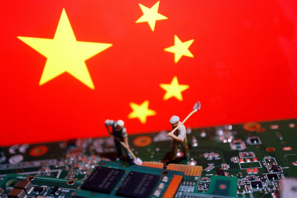 Worker miniatures are placed among the flag of China and printed circuit boards with semiconductor chips, in this illustration picture taken July 5, 2023. REUTERS/Florence Lo/Illustration/File Photo
