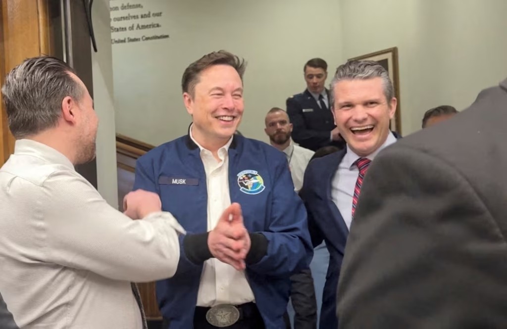 Elon Musk and U.S. Defence Secretary Pete Hegseth laugh at the Pentagon in Washington, D.C., U.S., March 21, 2025 in this screengrab obtained from a video. REUTERS/Idrees Ali