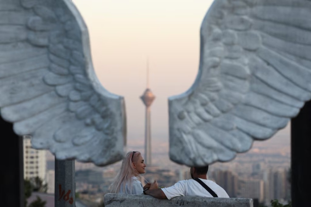  Iranian people in a park with a view of Milad Tower, in Tehran, Iran, June 15, 2026. Majid Asgaripour/WANA (West Asia News Agency) via REUTERS