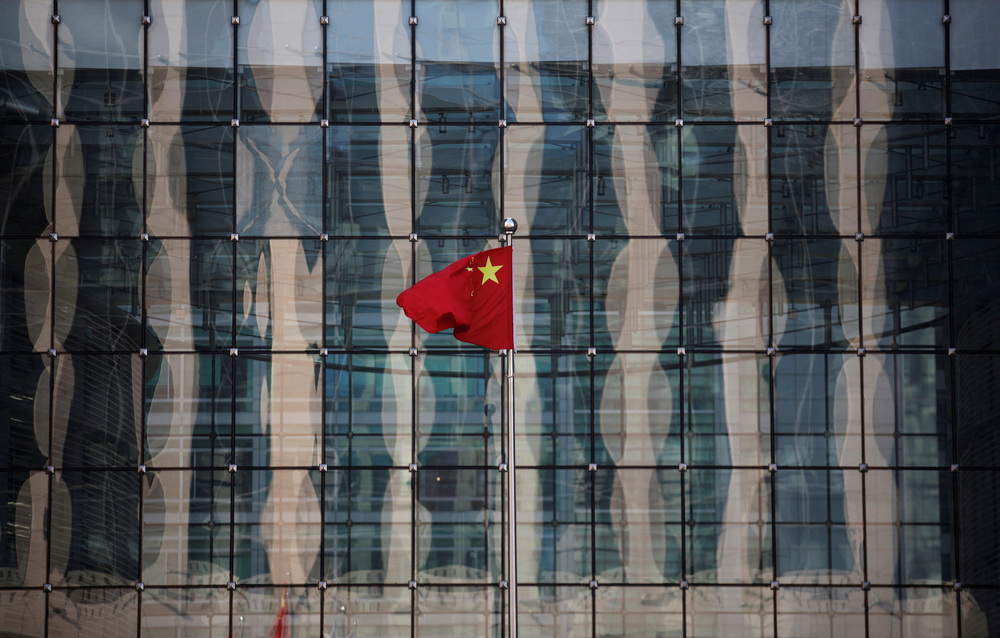 A Chinese national flag flutters at the headquarters of a commercial bank. REUTERS
