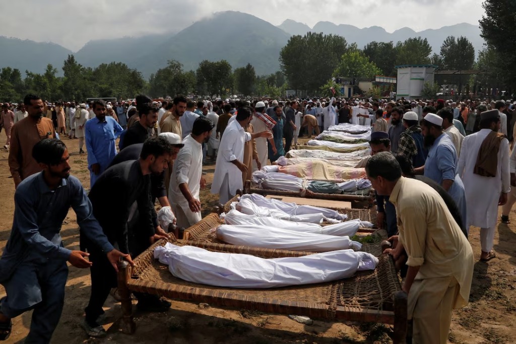People arrange cots with the bodies of victims as they prepare for their funeral following heavy rain and floods in Buner district in Khyber Pakhtunkhwa province, Pakistan, August 16, 2025. (REUTERS/Stringer)