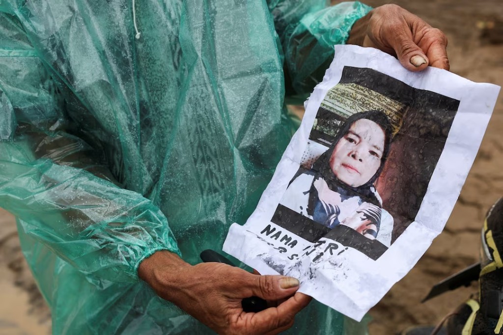 A local resident Abdul Ghani, 57, shows a photo of his wife Marsoni, who has been missing following deadly flash floods in Palembayan, Agam regency, West Sumatra province, Indonesia, December 2, 2025. REUTERS/Willy Kurniawan 