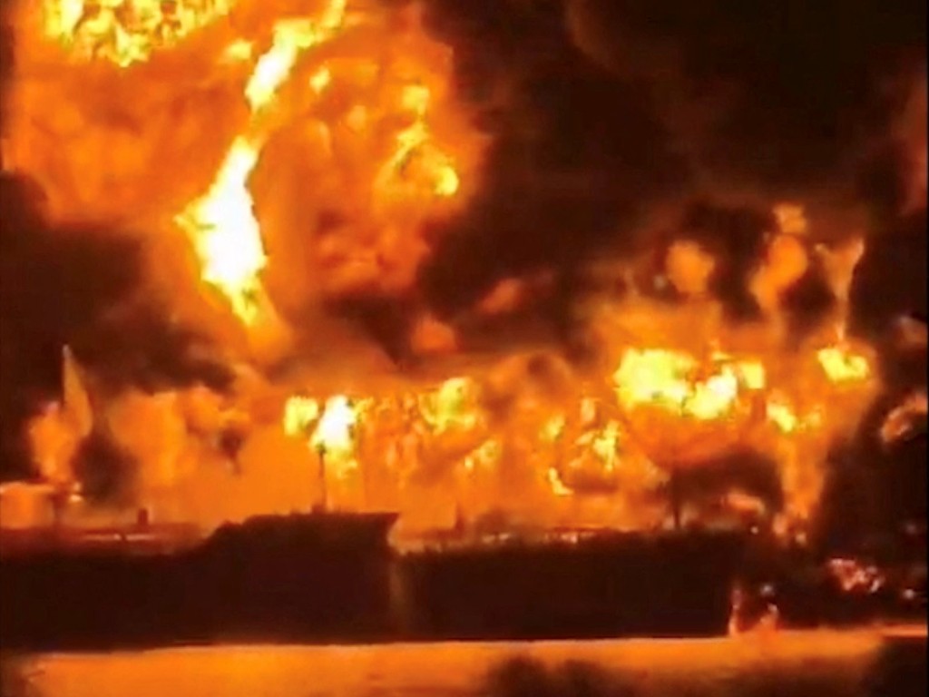 A ship is illuminated by fire from a burning vessel, after Iranian explosive-laden boats appear to have attacked two fuel tankers in Iraqi waters setting them ablaze, according to port, maritime security and risk firms, amid the U.S.-Israeli conflict with Iran. (Reuters)
