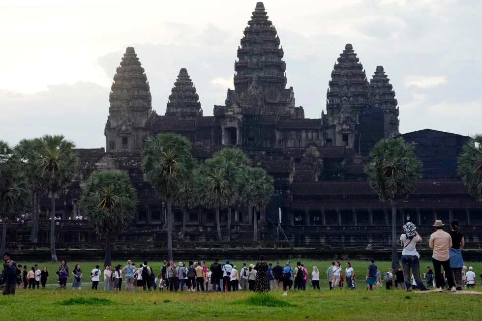Tourists wait for sunrise at the Angkor Wat temple in Siem Reap province, Cambodia, Friday, Aug. 2, 2024. (AP Photo/Heng Sinith, File)