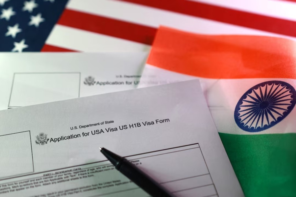U.S. and Indian flags and U.S. H-1B Visa application forms are seen in this illustration taken, September 22, 2025. REUTERS/Dado Ruvic/Illustration/File Photo
