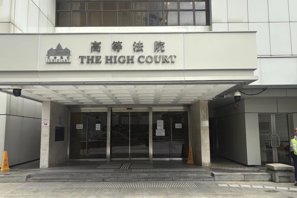 A security guard stands outside of Hong Kong’s High Court in Admiralty, Hong Kong Wednesday, July 23, 2025. (AP Photo/Kanis Leung)