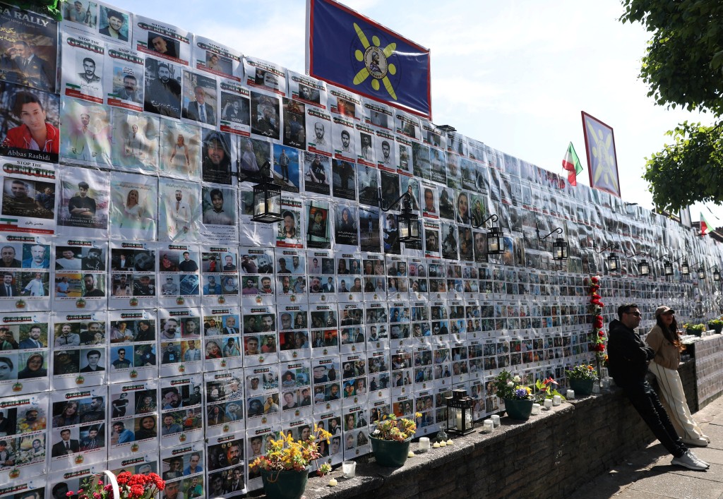 People stop beside a memorial wall on Limes Avenue in Golders Green. (Reuters/File)