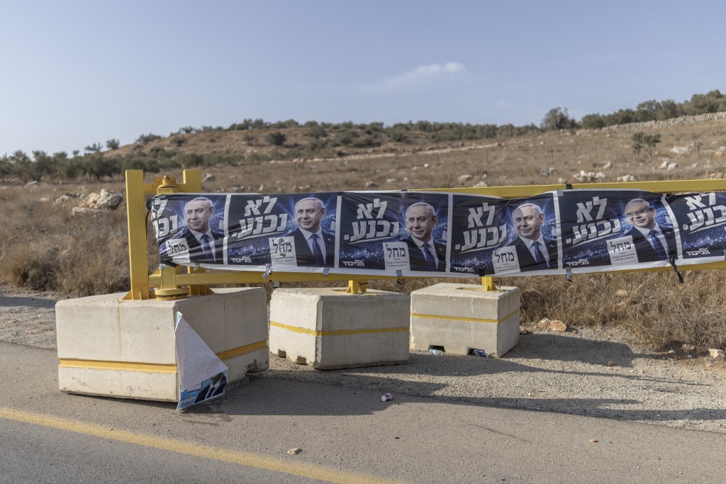 Photo by ILIA YEFIMOVICH / AFP  This photograph shows campaign banners of Israeli Prime Minister Benjamin Netanyahu's Likud party hanging on a security gate at the settlement of Bet Aria in the Israeli-occupied West Bank on October 13, 2026.