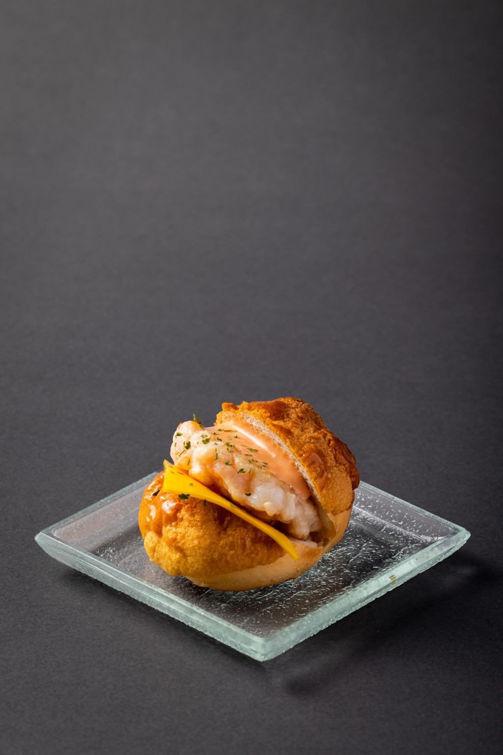 Mini Cheese Shrimp Pineapple Bun Burger (Maxim’s Cakes, festival exclusive) - a crisp-topped mini pineapple bun is filled with springy shrimp paste and double cheese, giving a playful savory twist to a Hong Kong bakery favorite.