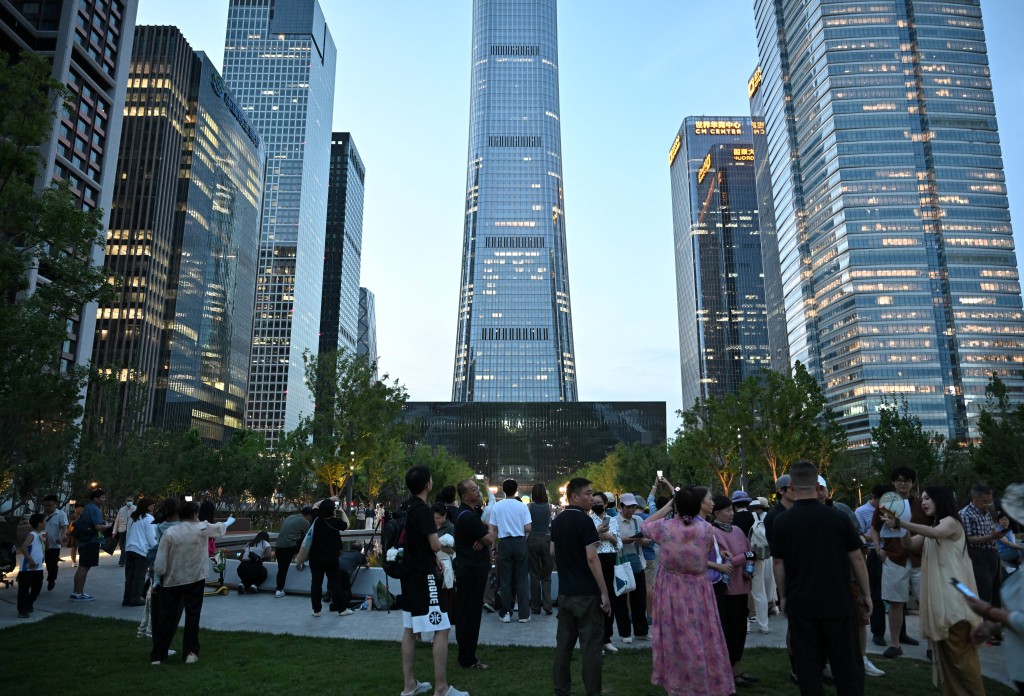 Photo by ADEK BERRY / AFP  People gather near the CITIC Tower in Beijing on June 26, 2026, after an eyewitness reported plane debris at the base of Beijing's tallest building.People gather near the CITIC Tower in Beijing on June 26, 2026, after an eyewitness reported plane debris at the base of Beijing's tallest building.