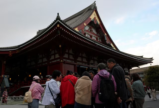 A Chinese tourist group stands near the Sensoji temple in Tokyo. REUTERS/Issei Kato 