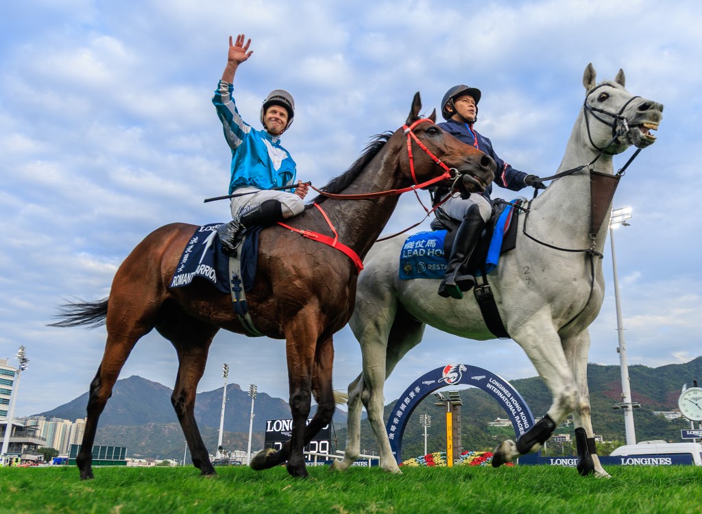James McDonald waves to the crowd after Romantic Warrior makes history at Sha Tin. Grant Courtney/Idol Horse