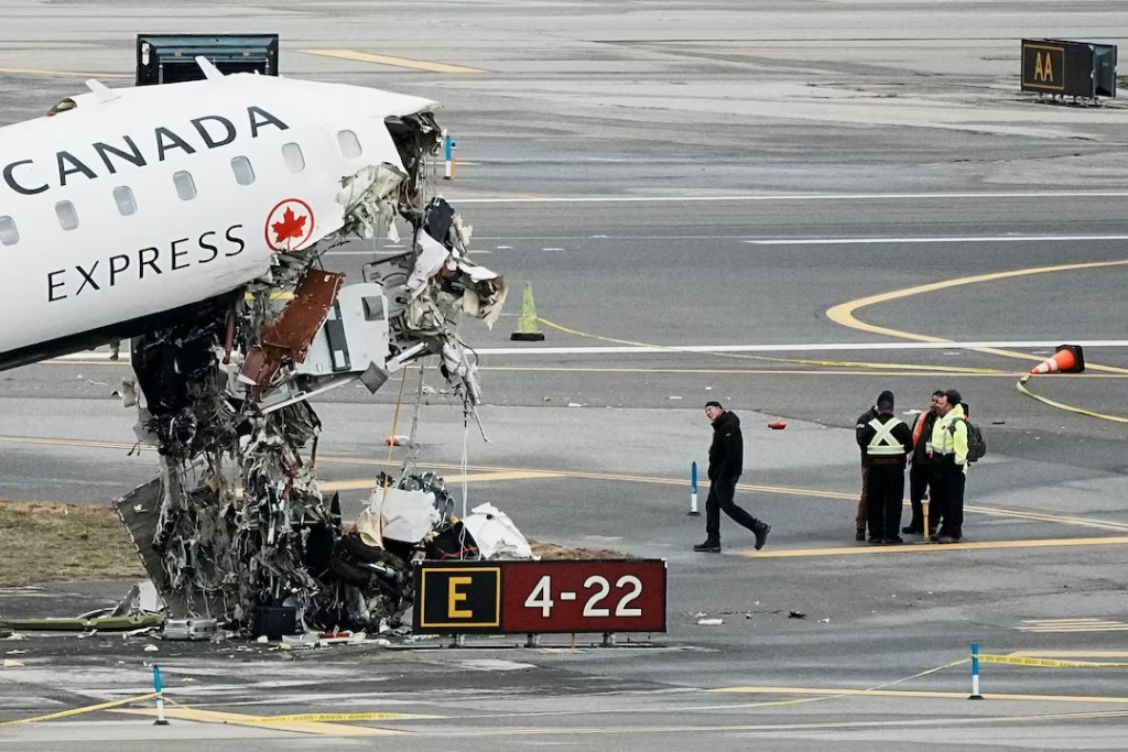 Personnel of the National Transportation Safety Board (NTSB) inspect the wreckage of an Air Canada Express jet that collided with a fire truck at New York's LaGuardia Airport in Queens, New York, U.S., March 23, 2026. REUTERS/Eduardo Munoz 