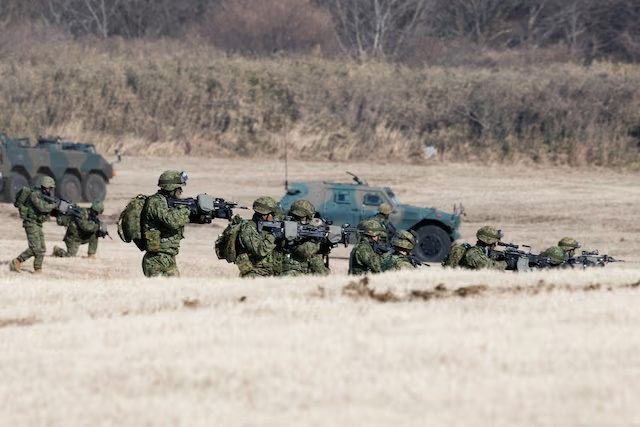 Military personnel take part in an annual New Year military drill by the Japanese Ground Self-Defense Force 1st Airborne Brigade at Narashino exercise field in Funabashi, east of Tokyo, Japan January 11, 2026. REUTERS/Kim Kyung-Hoon/File Photo