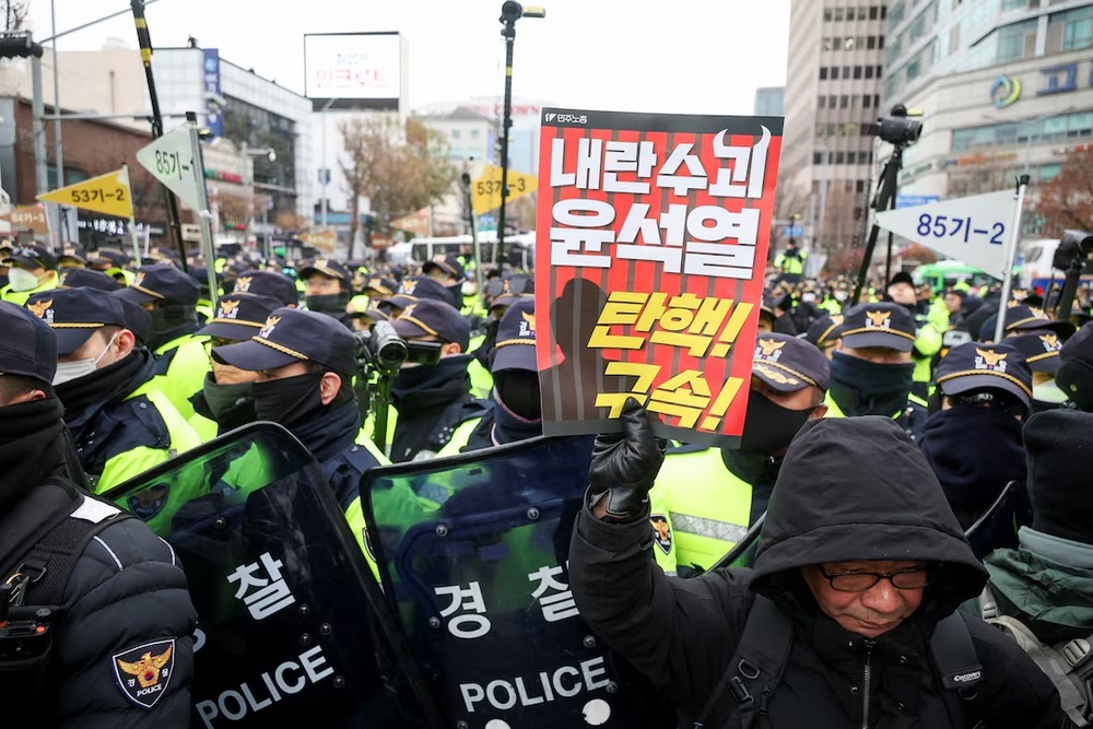 Police block the road to stop protestors marching during a rally calling for the impeachment of South Korean President Yoon Suk Yeol, who declared martial law, which was reversed hours later, in Seoul, South Korea, December 12, 2024. REUTERS/Kim Hong-Ji Police block the road to stop protestors marching during a rally calling for the impeachment of South Korean President Yoon Suk Yeol, who declared martial law, which was reversed hours later, in Seoul, South Korea, December 12, 2024. REUTERS/Kim Hong-Ji
