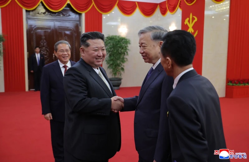 In this photo provided by North Korean government, North Korean leader Kim Jong Un, center, meets with Vietnamese Communist Party General Secretary To Lam, center right, at a stadium in Pyongyang, North Korea, Thursday, Oct. 9, 2025.  (Korean Central News Agency/Korea News Service via AP)