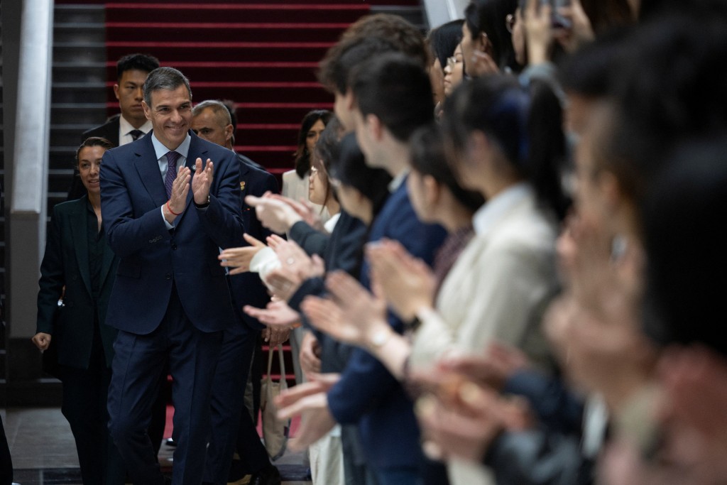 Spanish Prime Minister Pedro Sanchez arrives for a group photo with students at Tsinghua University in Beijing, China, 13 April 2026. (Reuters)
