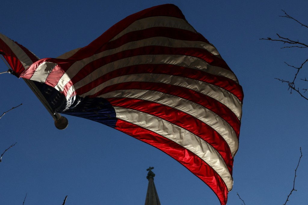 A U.S. flag flies in the wind outside St. Patrick's Cathedral along 5th avenue in New York City, U.S., April 6, 2026. REUTERS/Shannon Stapleton  