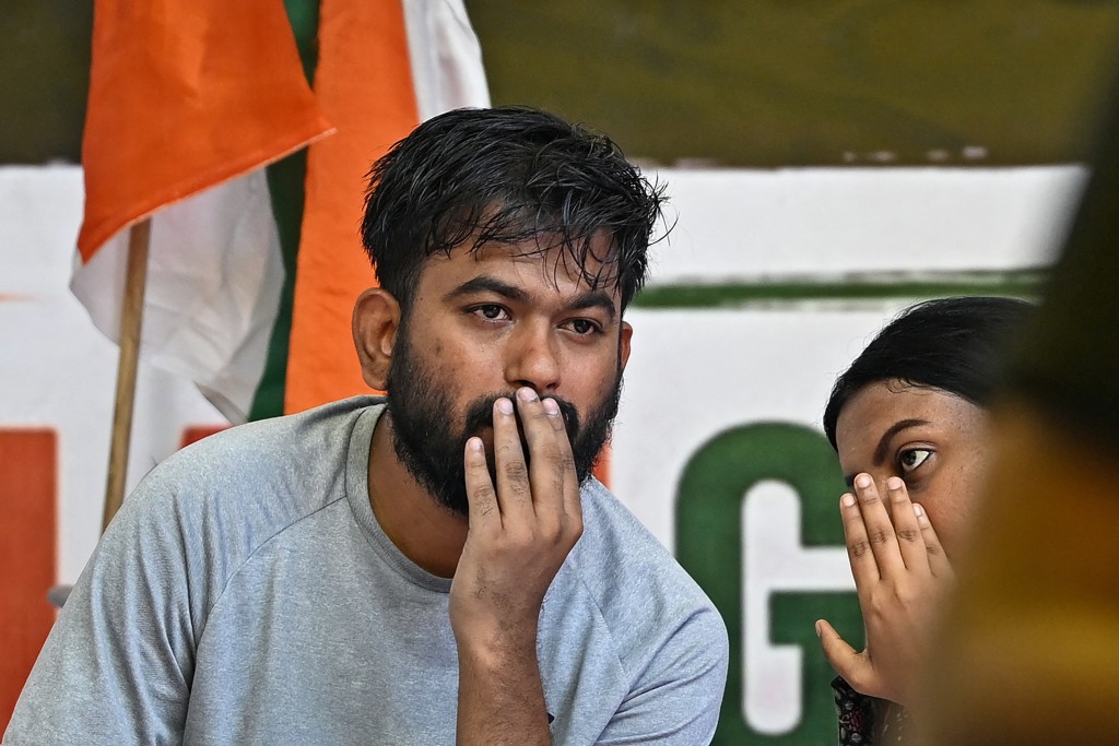 Cockroach Janta Party (CJP) founder Abhijeet Dipke (L) sits on an indefinite hunger strike demanding the resignation of India's Education Minister Dharmendra Pradhan over alleged NEET examination irregularities in New Delhi on July 19, 2026.
