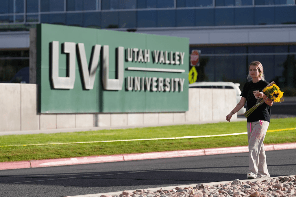 Meagan Bradley walks to a memorial for Charlie Kirk at Utah Valley University in Orem, Utah, Friday, Sept. 12, 2025. (AP Photo/Lindsey Wasson)