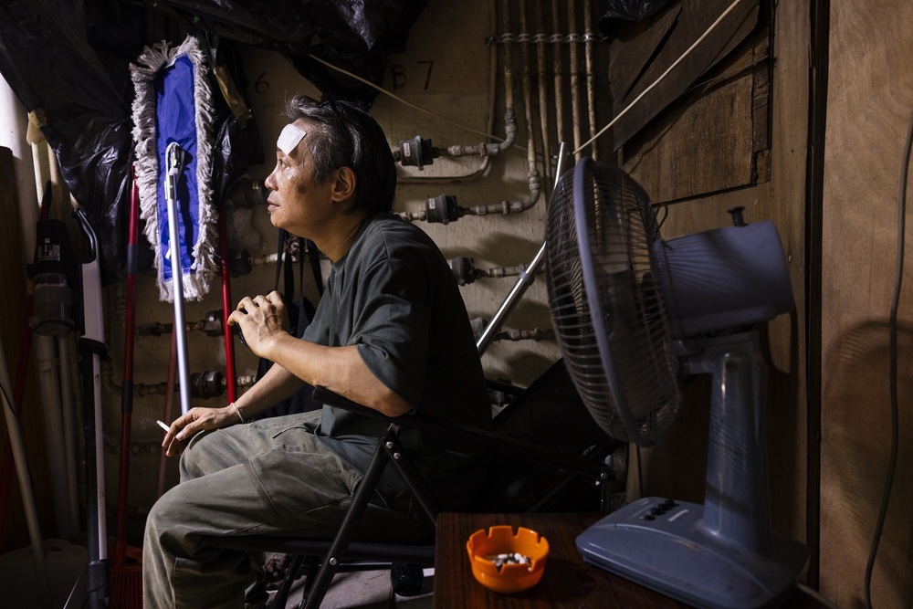 Joe Wong, a cleaner, rests while at work amid the summer heat in Hong Kong, Saturday, Aug. 5, 2023. (AP)