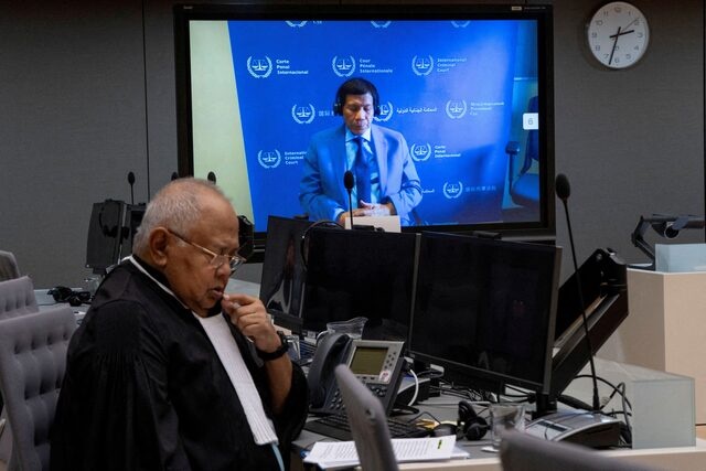 Former Philippine President Rodrigo Duterte is seen on a screen in the courtroom of the International Criminal Court (ICC) with his lawyer Salvador Medialdea seated left, in The Hague, Netherlands, Friday, March 14, 2025. Peter Dejong/Pool via REUTERS//File Photo