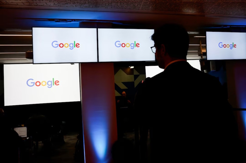 A man stands in front of Google logos during a media reception at the Google France headquarters ahead of the Artificial Intelligence Action Summit in Paris, France, February 9, 2025. REUTERS/Gonzalo Fuentes