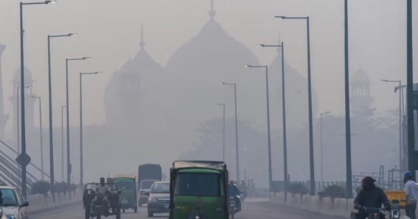 People commute along a street amid smoggy conditions in Lahore, Pakistan. (AFP) People commute along a street amid smoggy conditions in Lahore, Pakistan. (AFP)