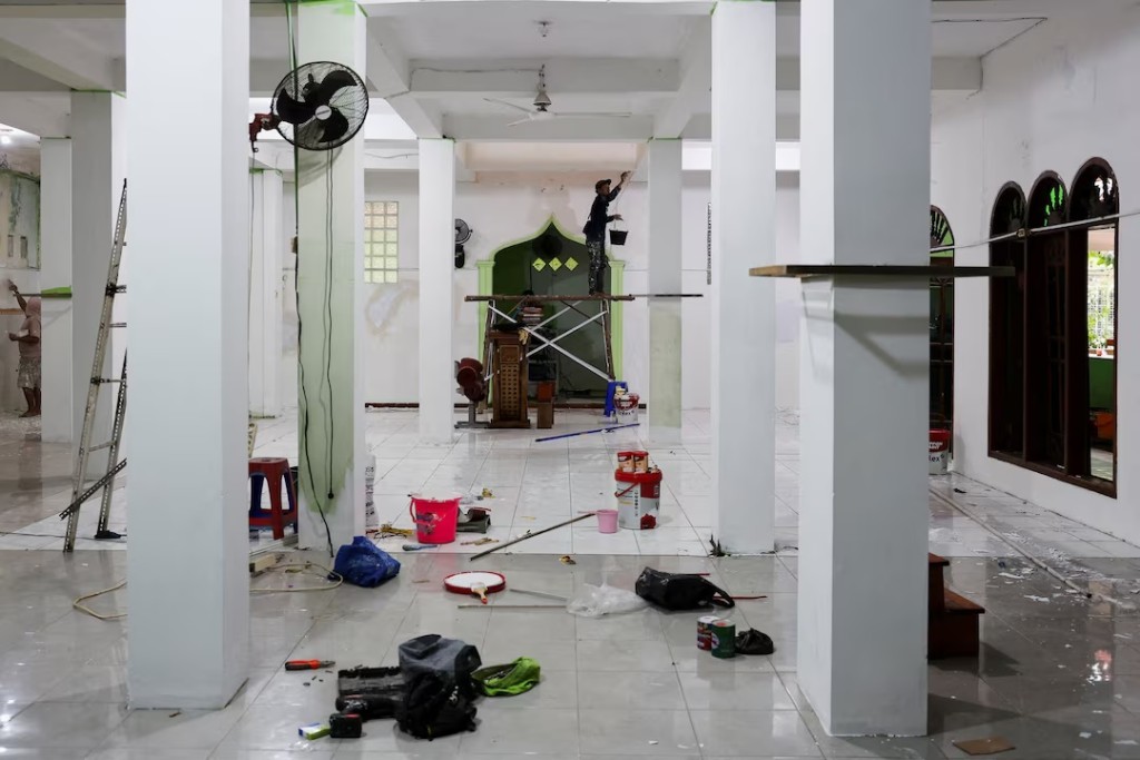 Workers work inside a mosque where explosions occurred the previous day, at a school complex in Jakarta, Indonesia, November 8, 2025. REUTERS/Willy Kurniawan/File Photo