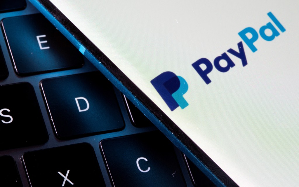 A smartphone with the PayPal logo is placed on a laptop in this illustration taken on July 14, 2021. REUTERS/Dado Ruvic